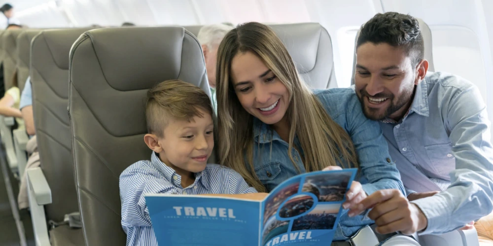 family reading a magazine on airplane